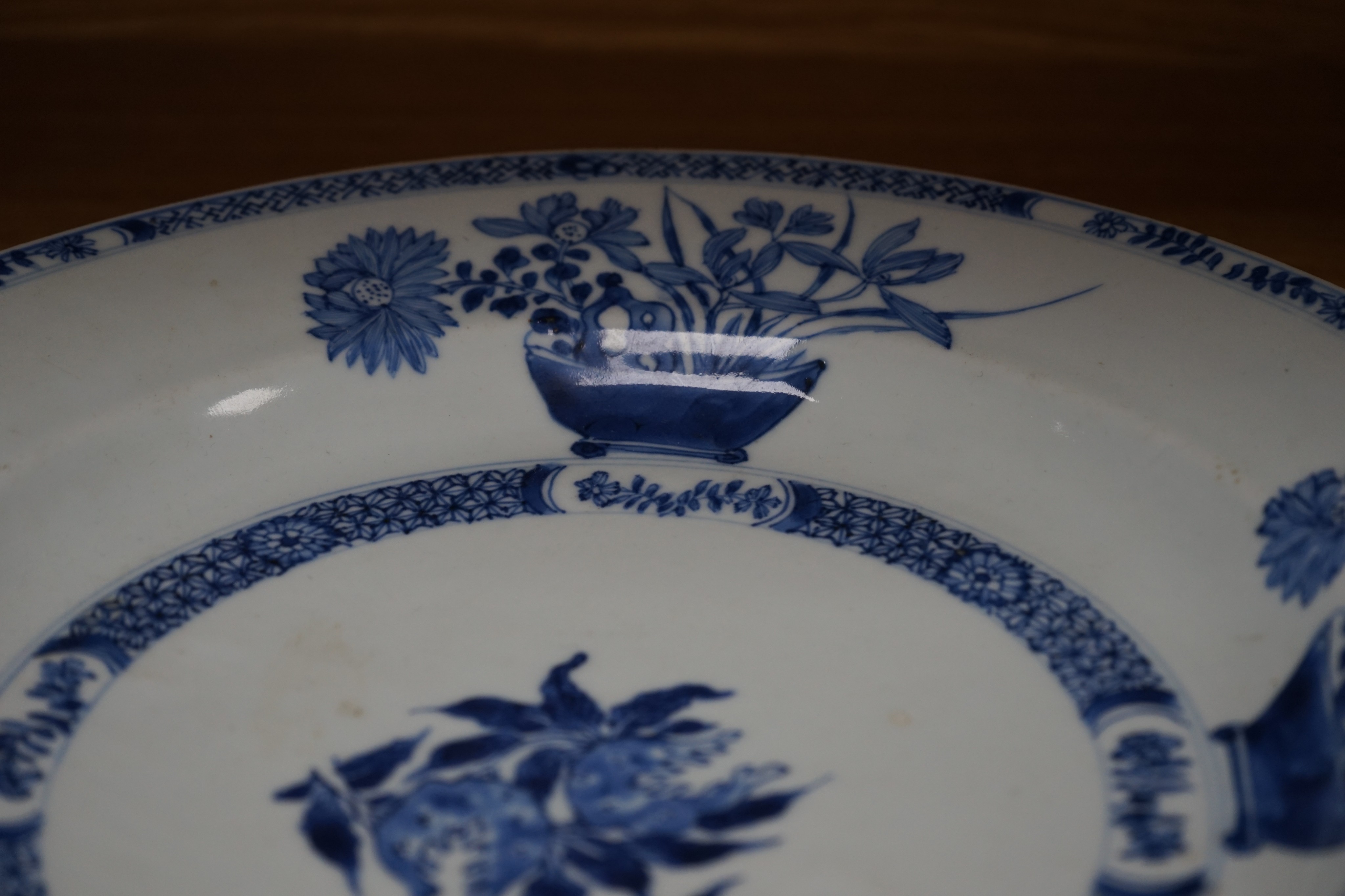 An 18th century Chinese blue and white circular dish decorated with flowering plants, Dia 32.5cm